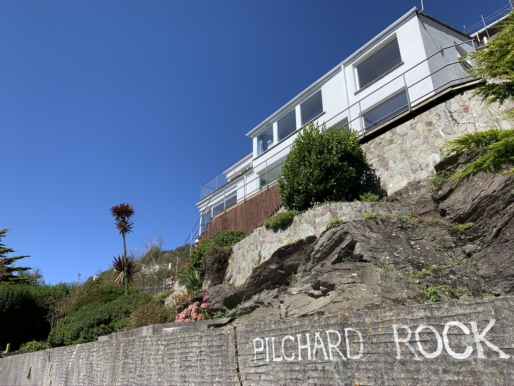 A large white house on a hill with deep blue sky behind